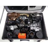 A camera case containing various cameras and lenses including Minolta,