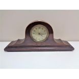 An early 20th century mahogany cased mantel clock with silver dial.