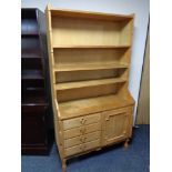 A set of continental blonde oak open bookshelves, fitted four drawers and cupboard beneath.