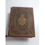 A 19th century leather bound family bible containing colour book plates.