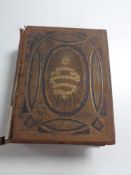 A 19th century leather bound family bible containing colour book plates.