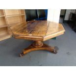 A 19th century octagonal oak tilt topped pedestal table.