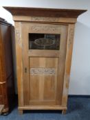 A 20th century carved oak single door cabinet CONDITION REPORT: Glass panel