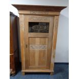 A 20th century carved oak single door cabinet CONDITION REPORT: Glass panel