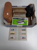 A box containing cased Omega 20 x 50 binoculars, a boxed stylophone,