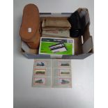 A box containing cased Omega 20 x 50 binoculars, a boxed stylophone,