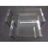 Two contemporary glass topped coffee tables on metal legs.