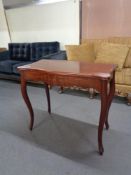 A late 19th century mahogany serpentine fronted turnover top table on cabriole legs.