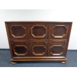 A 20th century oak six door, three drawer sideboard on bun feet.