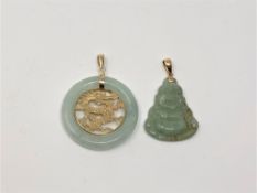 Two gold jade mounted pendants (2)