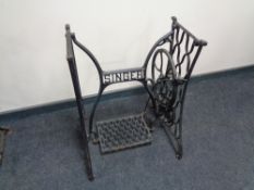 A cast iron Singer sewing machine treadle base.