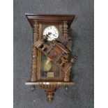 An antique Vienna wall clock with brass and enameled dial.