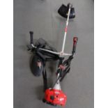 A Mountfield MB3302 petrol strimmer with harness.