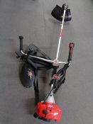 A Mountfield MB3302 petrol strimmer with harness.