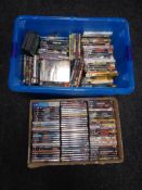 Two boxes and a crate containing a large quantity of assorted DVDs and CDs.