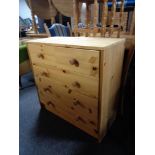 A contemporary pine five drawer chest.