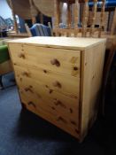 A contemporary pine five drawer chest.