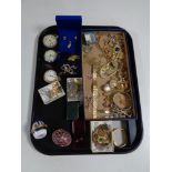 A tray containing a quantity of costume jewellery, chrome and silver plated pocket watches,
