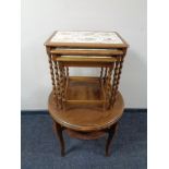 A nest of three tile topped barley twist leg tables together with a circular occasional table.