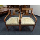 A pair of inlaid mahogany regency style armchairs together with a matching dining chair.