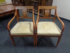 A pair of inlaid mahogany regency style armchairs together with a matching dining chair.