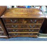 An inlaid yew wood five drawer chest on bracket feet.
