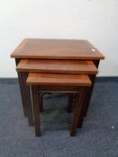 A nest of three inlaid yew wood tables together with an oval yew wood pedestal wine table.
