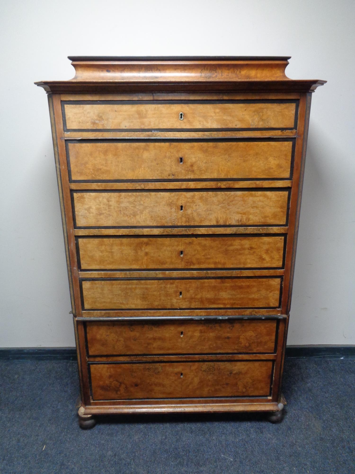 A 19th century continental seven drawer chest on bun feet (as found).