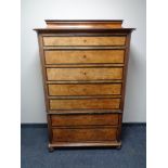 A 19th century continental seven drawer chest on bun feet (as found).