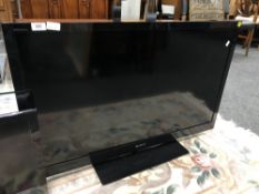 A Sony Bravia 40'' LCD TV with remote.