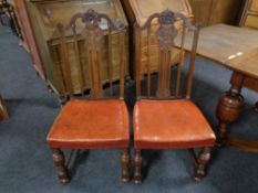 A set of eight carved oak high back dining chairs with leather seats.