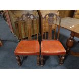 A set of eight carved oak high back dining chairs with leather seats.