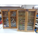 Two pine double door glazed wall cabinets containing sewing threads.
