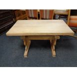 A blonde oak refectory dining table.