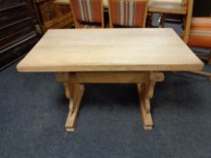 A blonde oak refectory dining table.