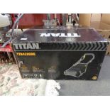 A boxed Titan lawn scarifier together with Titan pole saw attachments and a bundle of garden tools.