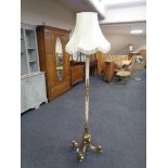 An ornate, heavy brass and onyx ornate standard lamp with shade.