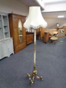An ornate, heavy brass and onyx ornate standard lamp with shade.