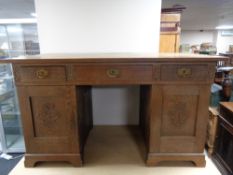 An early 20th century oak twin pedestal desk.