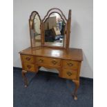 A 20th century walnut Queen Anne dressing table together with triple dressing table mirror (as