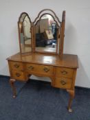 A 20th century walnut Queen Anne dressing table together with triple dressing table mirror (as