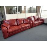 A Duresta red leather three seater settee with matching two seater settee