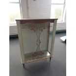 A mid century sliding glass door display cabinet