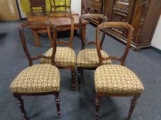 A set of four antique stained beech dining chairs.