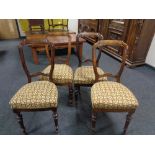 A set of four antique stained beech dining chairs.