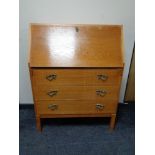 A 20th century oak writing bureau, fitted three drawers.