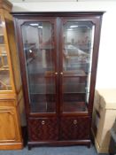 A Stag Minstrel double door glazed display cabinet, fitted cupboards beneath.