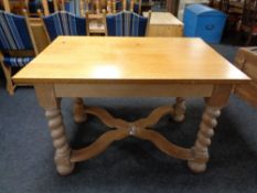 An early 20th century oak dining table on barley twist legs with under stretcher.