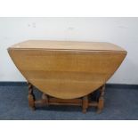 An Edwardian oak barley twist gate leg table.