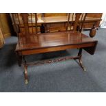 A mahogany flap sided sofa coffee table.